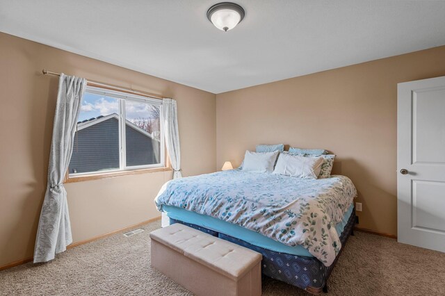 bedroom with carpet flooring, baseboards, and visible vents