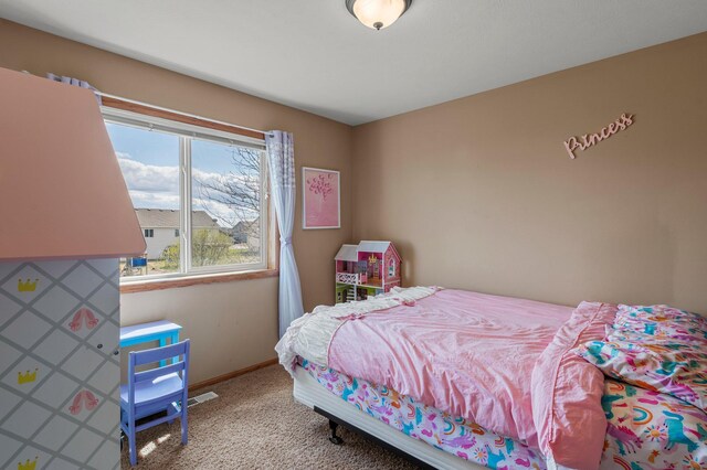 carpeted bedroom featuring baseboards