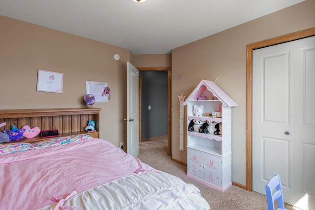 bedroom with baseboards and carpet flooring