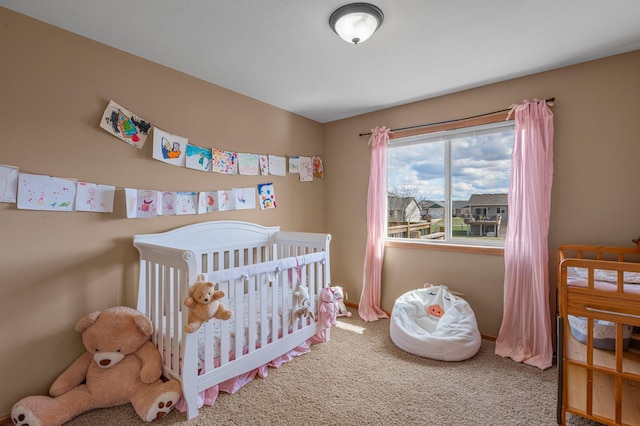 carpeted bedroom featuring a nursery area