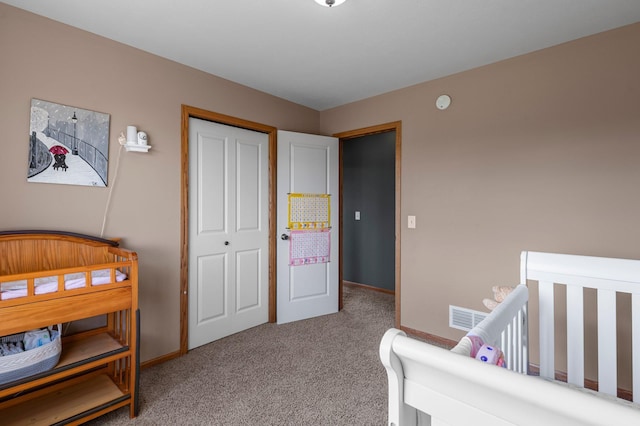 bedroom with baseboards, visible vents, carpet, and a closet