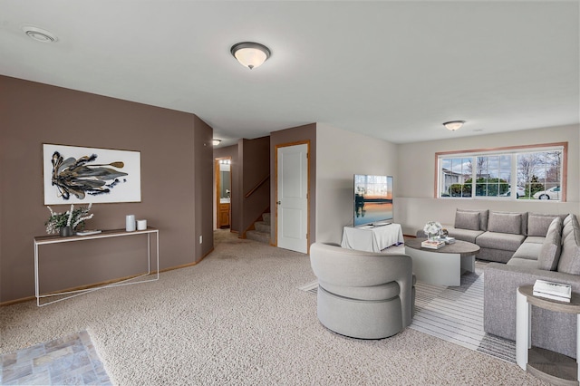 living room with carpet and stairway