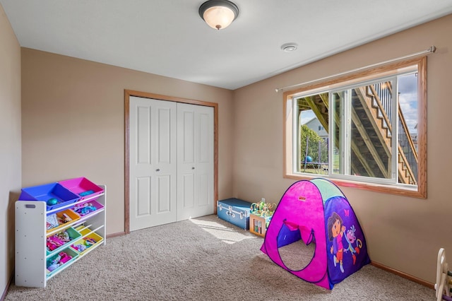recreation room featuring baseboards and carpet flooring