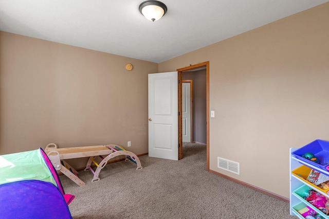 carpeted bedroom with visible vents and baseboards