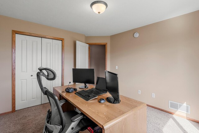 office area with visible vents, carpet flooring, and baseboards