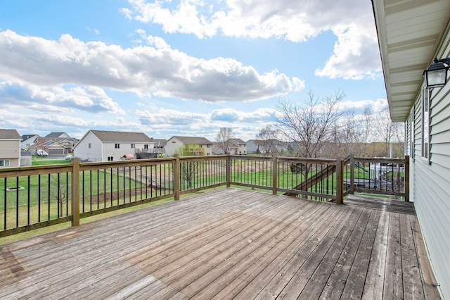 wooden terrace with a lawn and a residential view