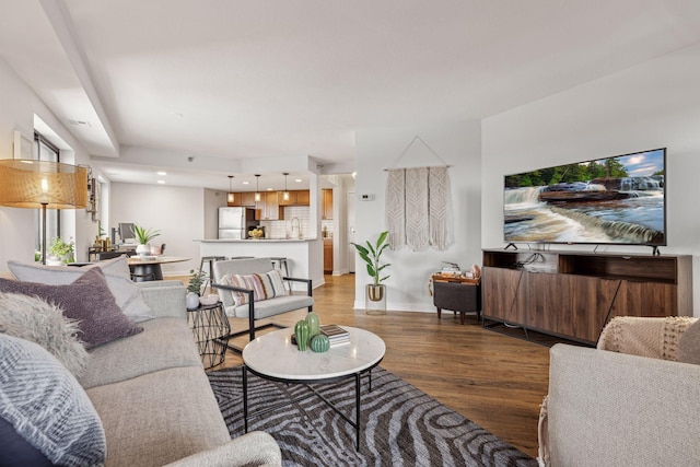 living room with recessed lighting, baseboards, and wood finished floors