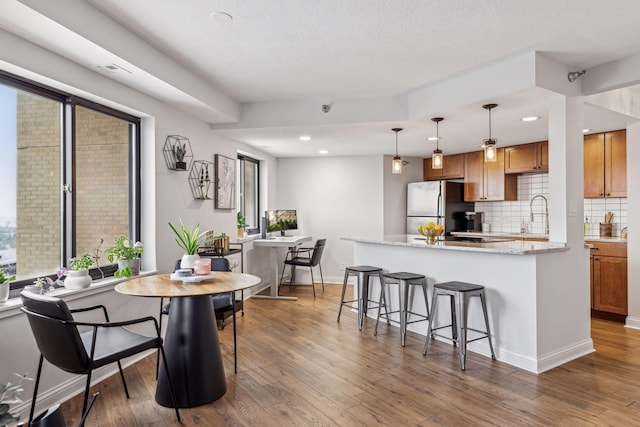 dining space with recessed lighting, dark wood finished floors, and baseboards