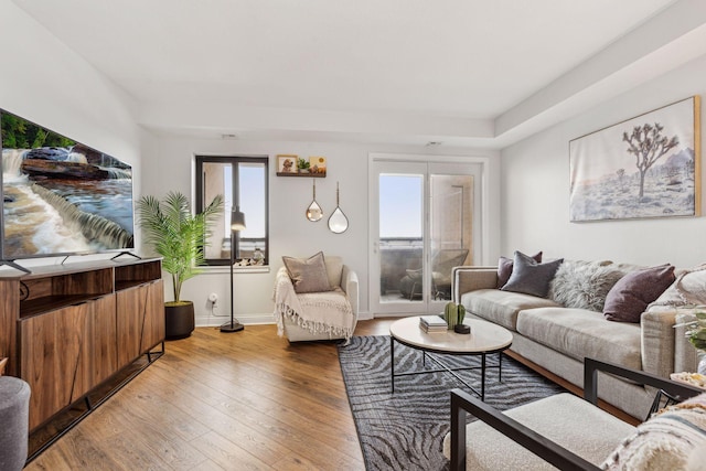 living area with wood finished floors and baseboards