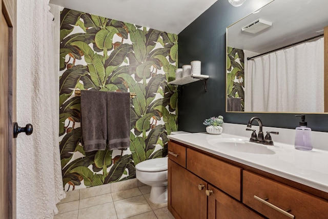 bathroom featuring vanity, tile patterned flooring, and toilet