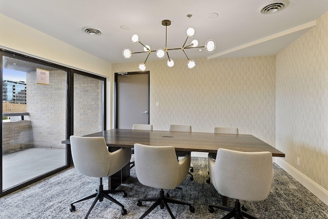 dining space with wallpapered walls, baseboards, and visible vents