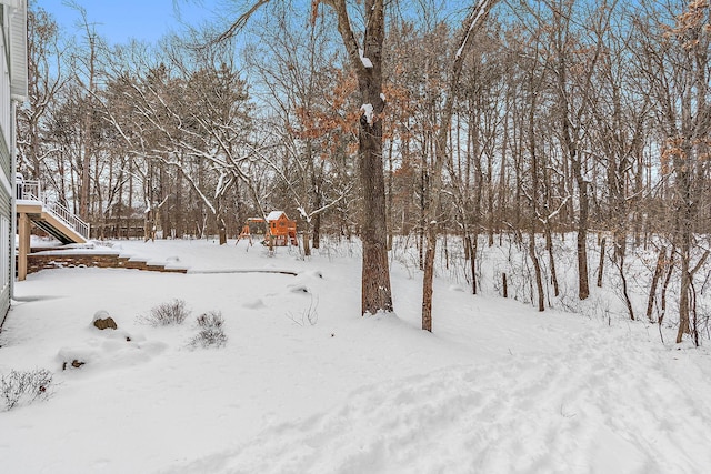 snowy yard with a garage