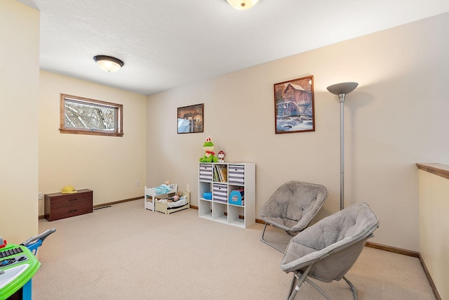 interior space with carpet floors, baseboards, and a textured ceiling