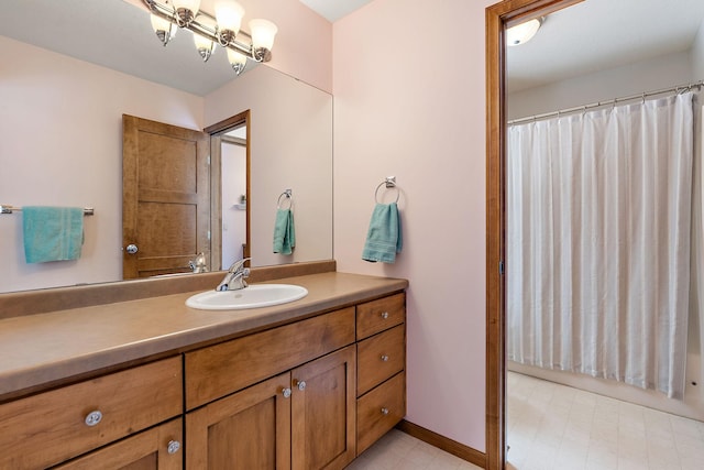 bathroom with tile patterned floors, baseboards, and vanity