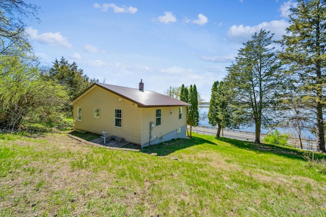 rear view of property featuring metal roof and fence