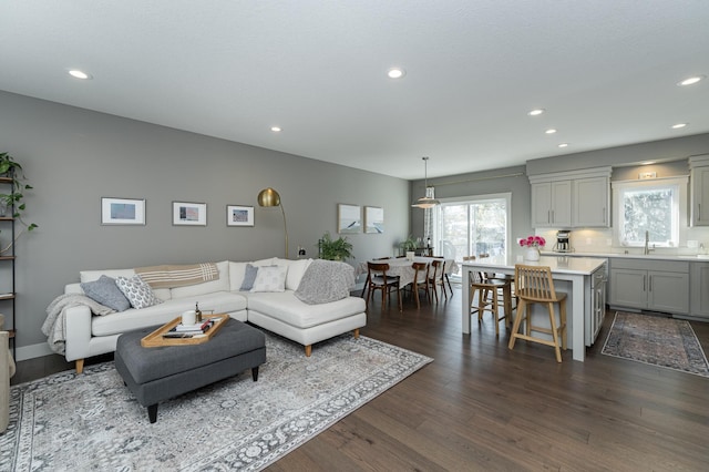 living area featuring dark wood finished floors and recessed lighting