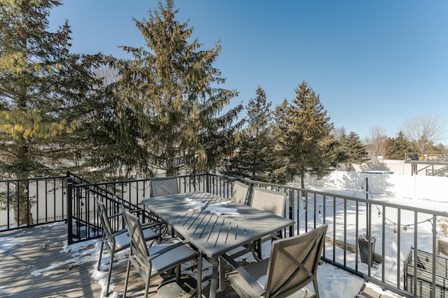 deck with outdoor dining space and fence