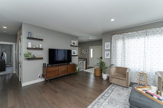 living area with recessed lighting, baseboards, and dark wood finished floors