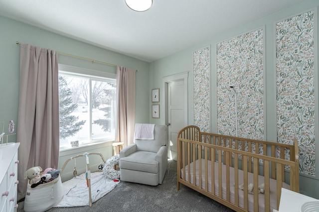 bedroom with a nursery area and carpet