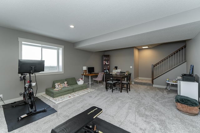 exercise area featuring recessed lighting, a textured ceiling, baseboards, and carpet floors