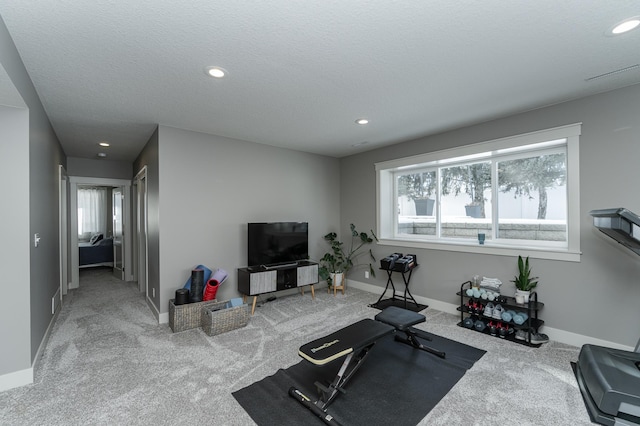 exercise room with recessed lighting, a healthy amount of sunlight, baseboards, and carpet floors