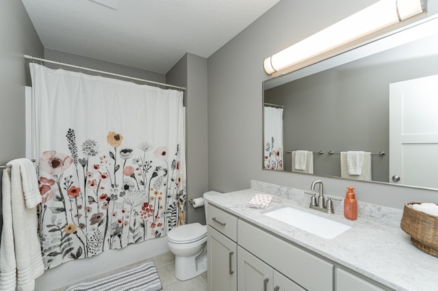 full bath featuring a textured ceiling, toilet, vanity, and tile patterned flooring