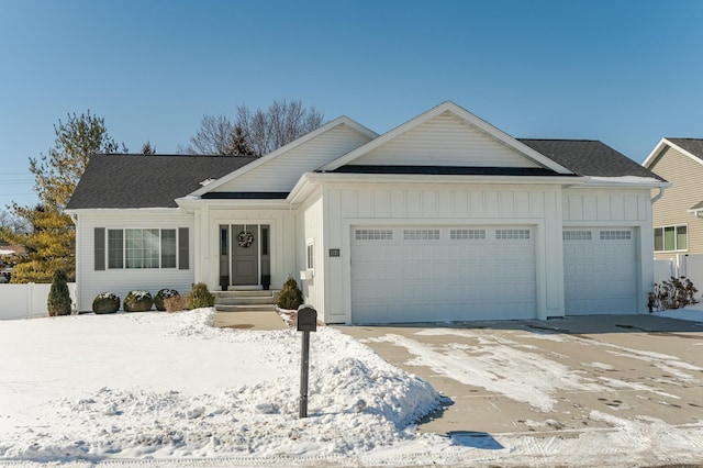 ranch-style house with an attached garage, board and batten siding, and a shingled roof