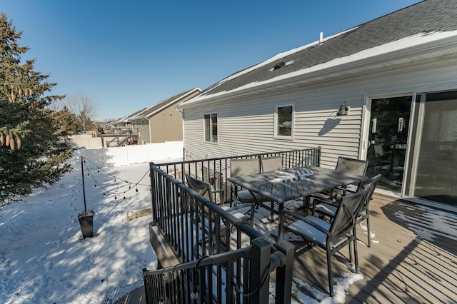 wooden deck featuring outdoor dining area and fence