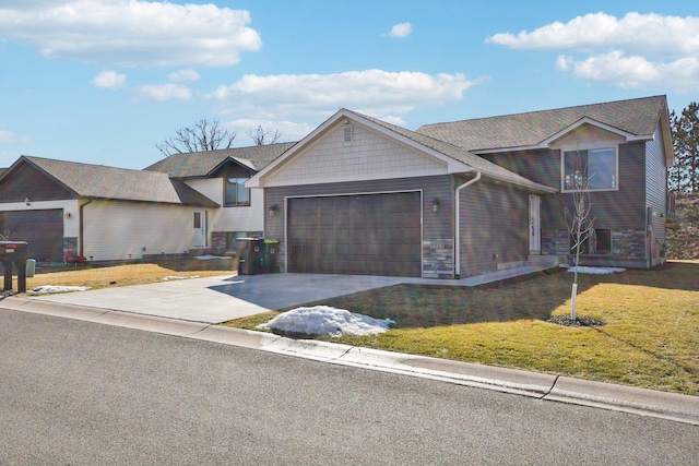 view of front of property with an attached garage, concrete driveway, and a front yard