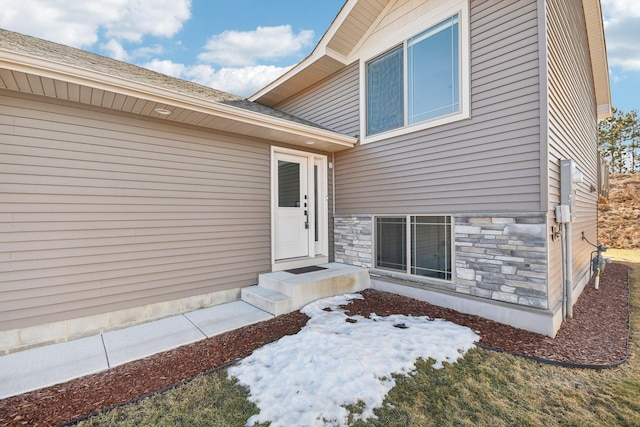 doorway to property featuring stone siding