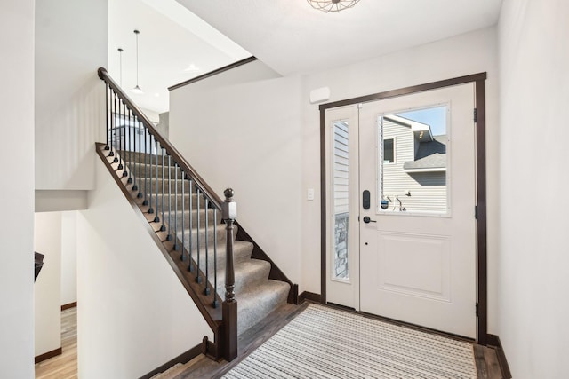 entrance foyer featuring baseboards and wood finished floors