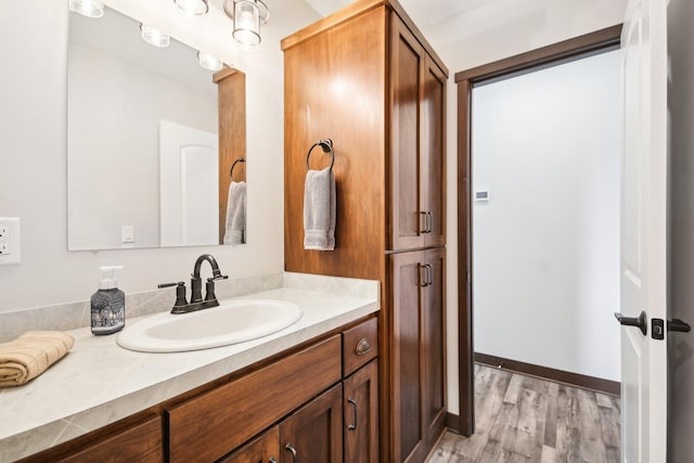 bathroom with vanity and wood finished floors