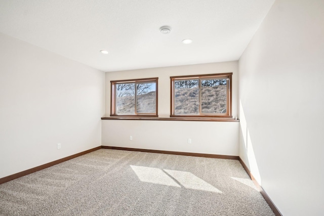 spare room with baseboards, carpet flooring, and recessed lighting