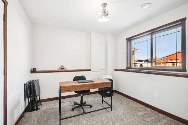 home office with carpet floors, visible vents, and baseboards