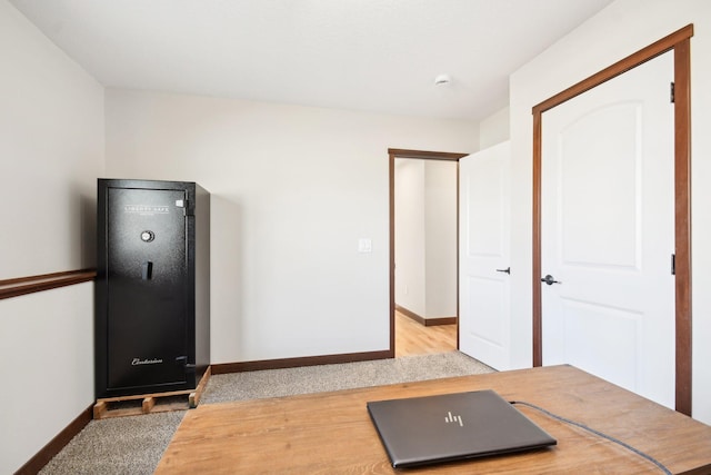 exercise room featuring light wood-style floors and baseboards