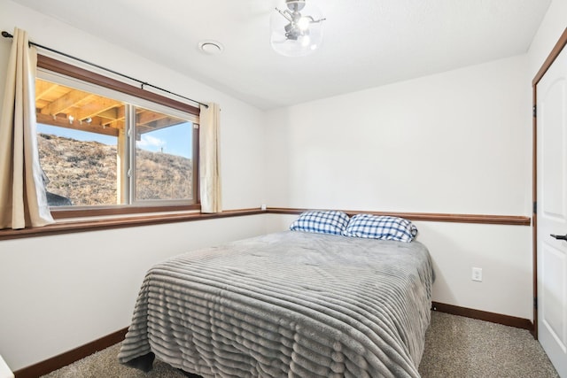 bedroom with carpet flooring and baseboards