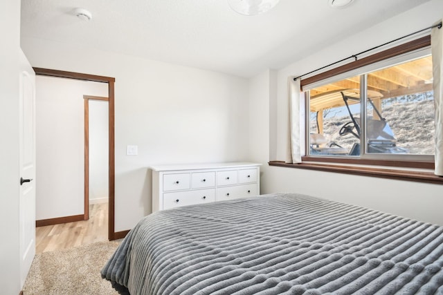 bedroom featuring baseboards and wood finished floors