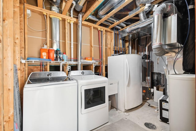 laundry area with washer and dryer, gas water heater, and laundry area