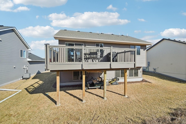 back of property featuring a yard, a wooden deck, and central AC unit