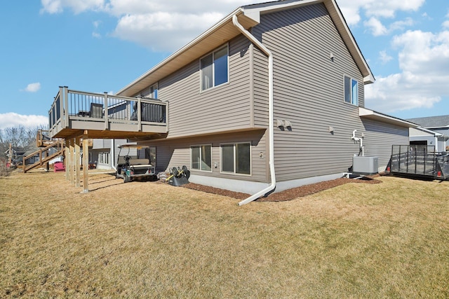 rear view of property with central AC, a yard, stairway, and a wooden deck