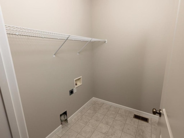 clothes washing area with laundry area, baseboards, visible vents, hookup for a washing machine, and hookup for an electric dryer