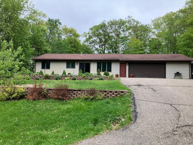 single story home with an attached garage, driveway, and a front yard