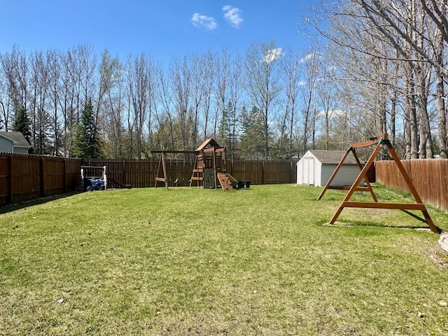 view of yard featuring a playground, a shed, and an outbuilding