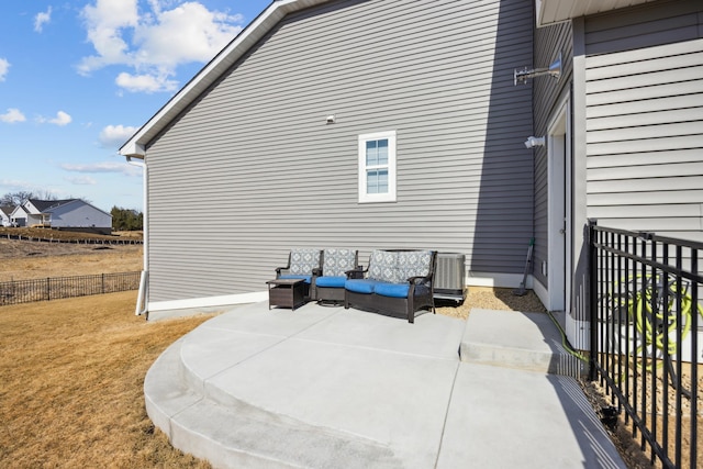 view of side of home featuring a lawn and fence