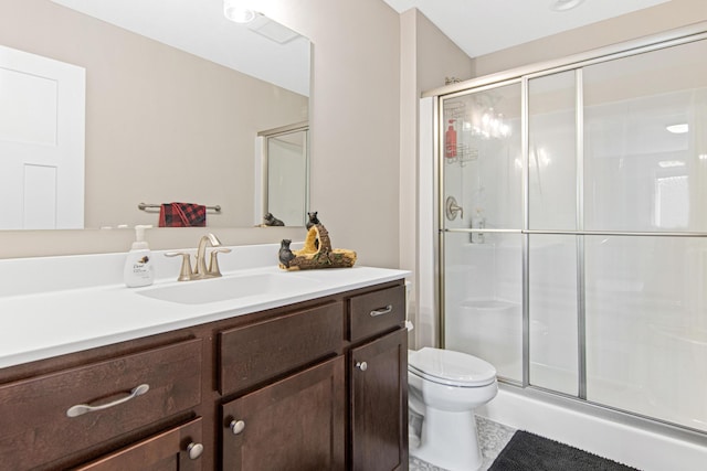 bathroom featuring toilet, a stall shower, and vanity