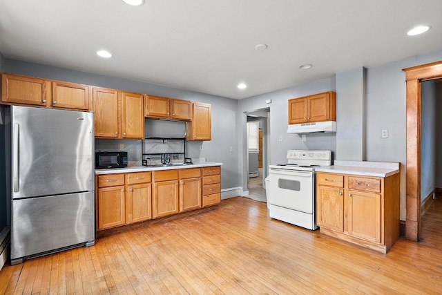 1498 Sherburne Ave, Saint Paul, MN 55104 - kitchen with freestanding refrigerator, white electric stove, under cabinet range hood, black microwave, and light countertops