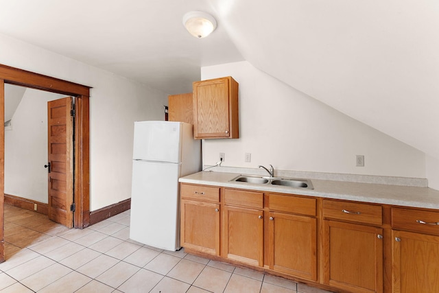 1498 Sherburne Ave, Saint Paul, MN 55104 - kitchen with a sink, freestanding refrigerator, lofted ceiling, light countertops, and light tile patterned floors
