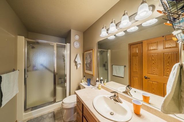 full bath featuring toilet, a shower stall, vanity, and tile patterned floors