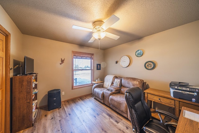 office with wood-type flooring, baseboards, ceiling fan, and a textured ceiling