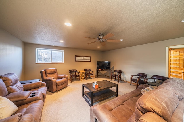 carpeted living area featuring a textured ceiling, a ceiling fan, and recessed lighting